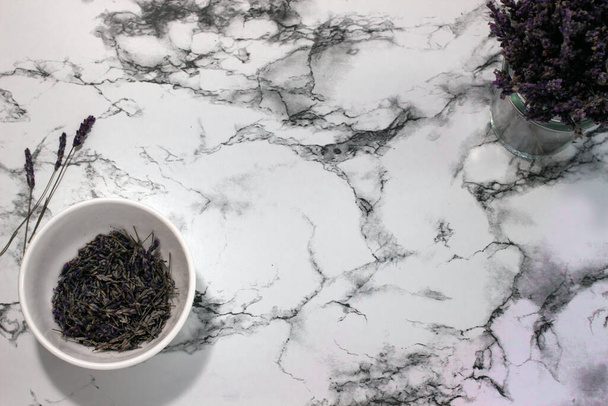 Flat lay composition with lavender flowers and natural cosmetic on marble background - Valokuva, kuva