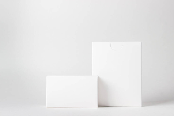 Two white boxes on a white background. On the boxes there is a place for inscriptions and logos - Foto, Imagem