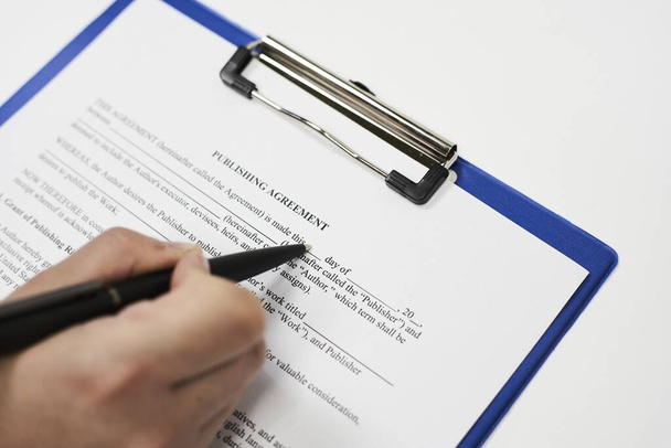 A closeup shot of a person filling in a legal document - Фото, изображение