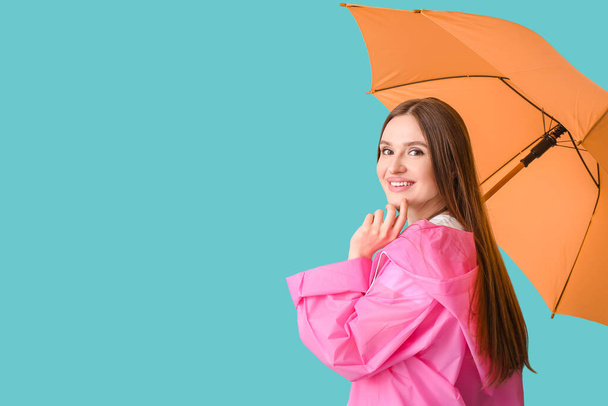 Beautiful woman with umbrella on color background - Photo, Image