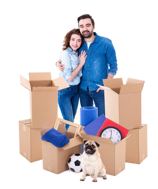 moving day concept - young couple with brown cardboard boxes and dog isolated on white background - Photo, Image
