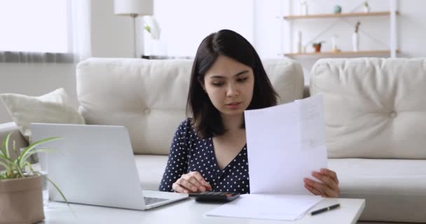 Woman checking bills feels upset due high prices or debt - Imágenes, Vídeo