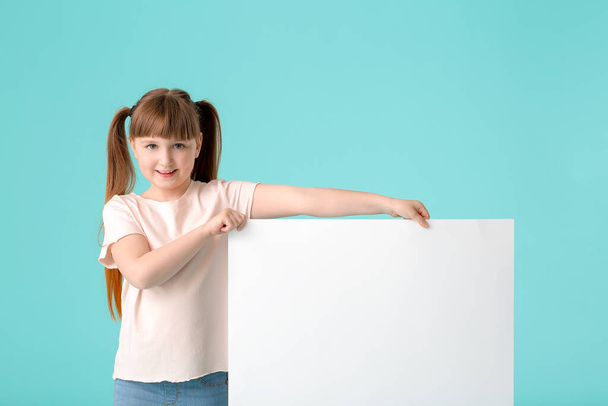 Little girl with blank poster on color background - Foto, immagini