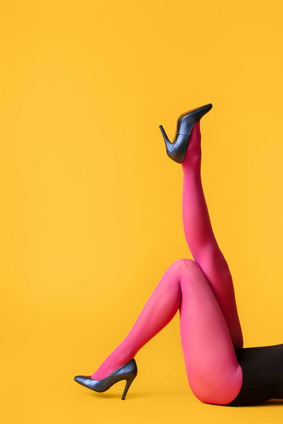 Beautiful young woman in tights on color background - Zdjęcie, obraz