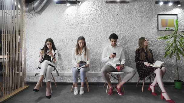Jobless applicants group sitting in queue waiting for job interview - Zdjęcie, obraz