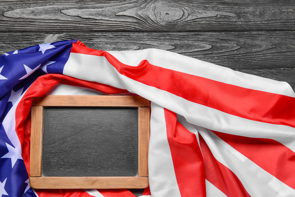 USA flag and chalkboard on dark wooden background - Φωτογραφία, εικόνα