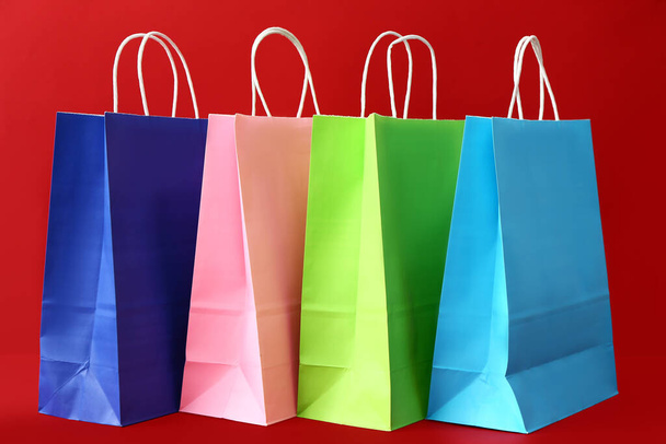 Paper shopping bags on color background - Zdjęcie, obraz
