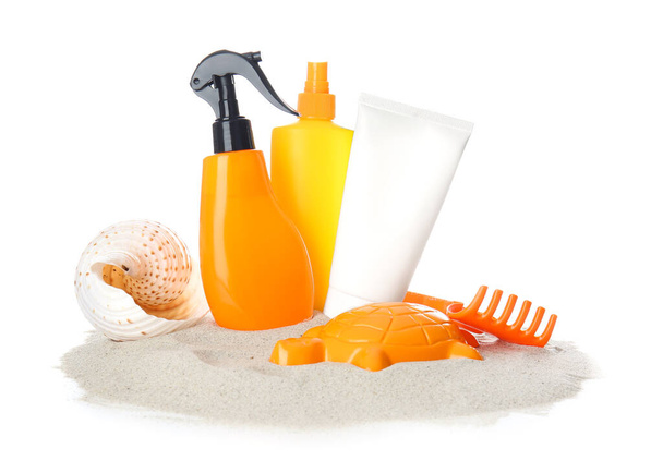 Sunscreen cream with beach sand toys on white background - Photo, Image