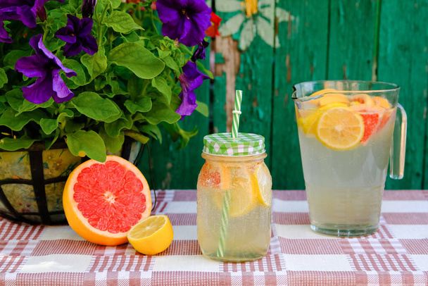 Making homemade lemonade from lemon and grapefruit. - Photo, Image