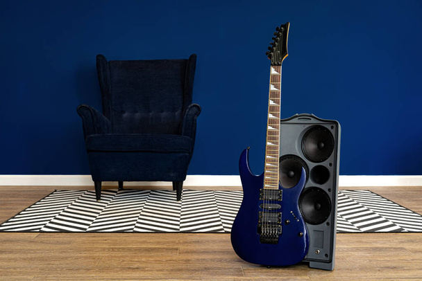 Guitar setup against classic blue wall in apartment - Foto, Imagen