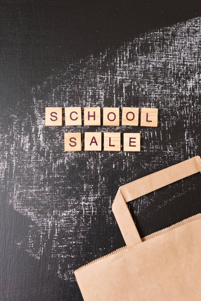 School sale with trendy shadow and different supplies on blackboard. Lettering school sale are made out of blocks - Fotoğraf, Görsel