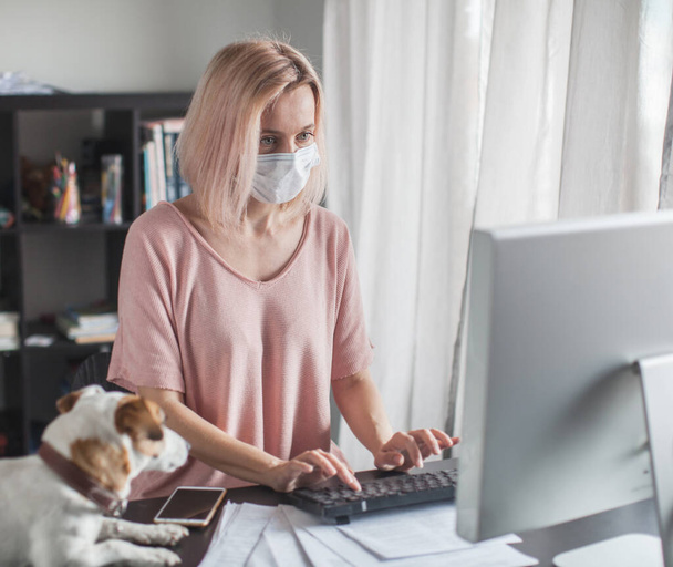 Business woman working from home wearing protective mask - Фото, зображення