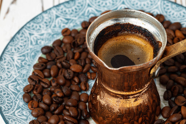 Coffee in copper turk on coffee beans - Zdjęcie, obraz