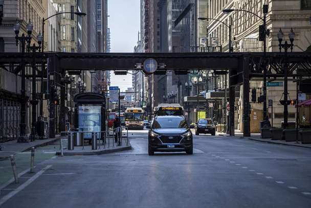 CHICAGO, UNITED STATES - Apr 18, 2020: The streets of Chicago downtown are isolated and empty due to the corona virus pandemic Covid-19. Business are shutdown from quarantine losing money - Photo, image