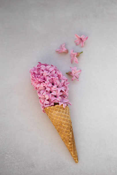 Summer or spring concept. Ice-cream cone with hyacinthus. - Fotó, kép