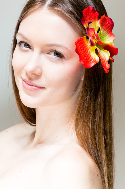 Beautiful girl face & flower. Perfect skin. - Photo, image
