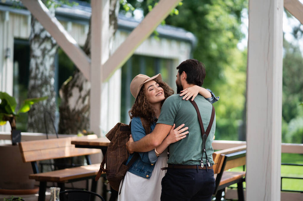 Happy couple greeting outdoors on terrace restaurant, end of lockdown. - Fotó, kép