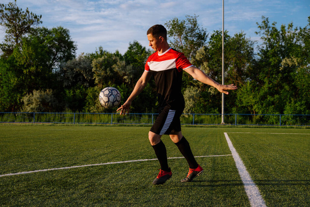 Soccer player kicks the ball.Football player kicks the ball on the football field.Football sports concept - Zdjęcie, obraz
