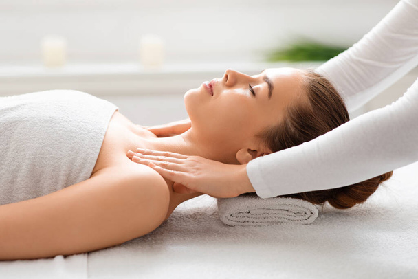 Woman getting body massage at white spa - Photo, Image