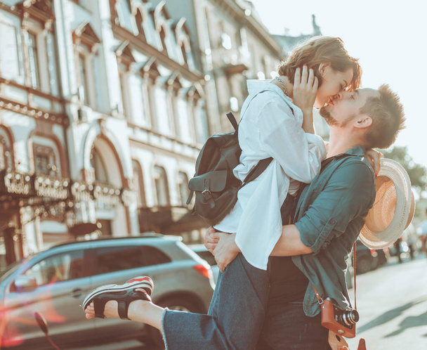 Cheerful cheerful hipster couple in love kissing at city. The romantic concept of lovers. love story - Fotografie, Obrázek