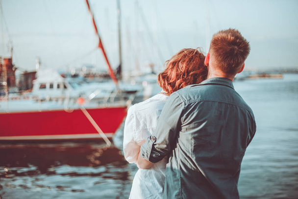 Romantic concept. Young couple in love at sea on a background of yachts club. Youth Lovestory - Фото, зображення