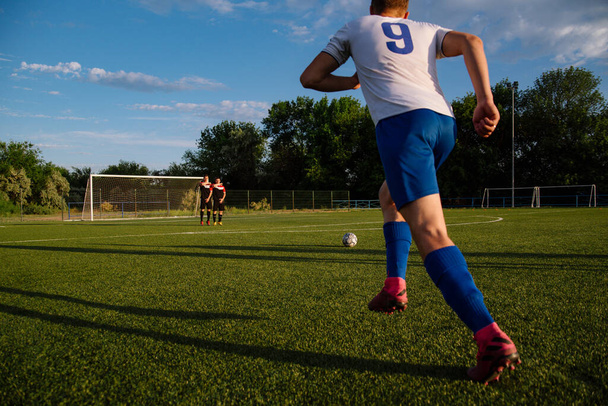 Soccer player kicks the ball.Soccer player takes the free-kick.Football player kicks the ball on the football field.Football sports concept - Фото, зображення