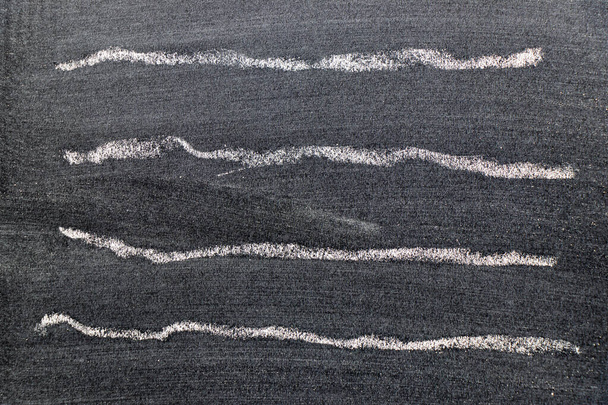 White color chalk hand drawing in set of wavy line shape on black board background - Fotó, kép