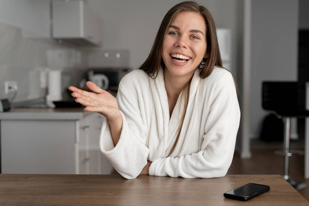 Happy friendly woman waving, looking at webcam camera, smiling and telling an interesting story to lady vlogger, recording a video blog or making a video call at home, lifestyle blogging, dating online, - Photo, Image