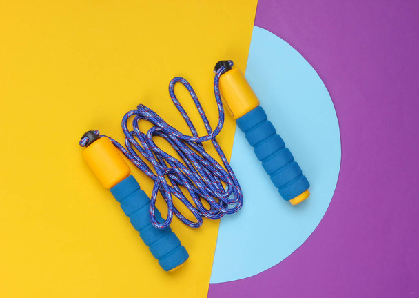 Skipping rope on colored background. Top view. Minimalistic sport concept. - Foto, immagini