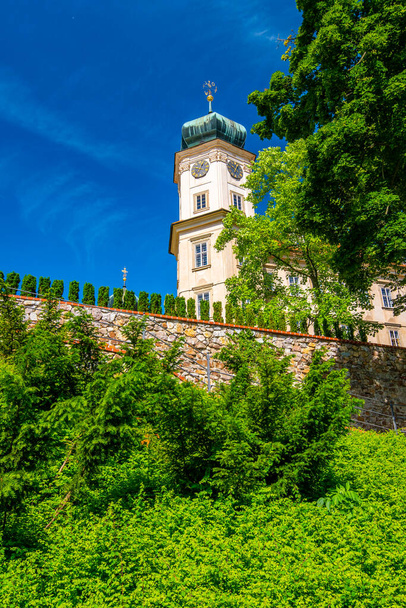 Historical chateau at Mnisek pod Brdy city, Czech Republic. View of ancient building with towers, built in gothic style. Sunny summer day, blue sky and vibrant colors. - 写真・画像