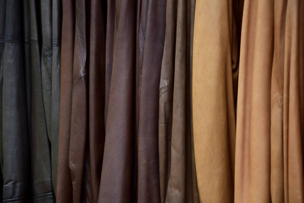 Veel verschillende leren jassen in verschillende kleuren te koop in de detailhandel - close-up en details - Foto, afbeelding