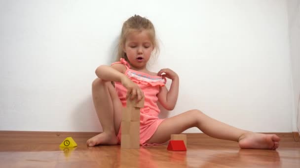 Pieni tyttö rakennus torni puiset tiilet - Materiaali, video