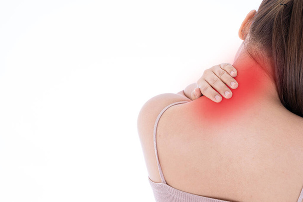 Eine Frau, die sich erschöpft fühlt und unter Schulter- und Nackenschmerzen und Verletzungen auf isoliertem weißen Hintergrund mit rotem Fleck leidet. Gesundheitsversorgung und medizinisches Konzept. - Foto, Bild
