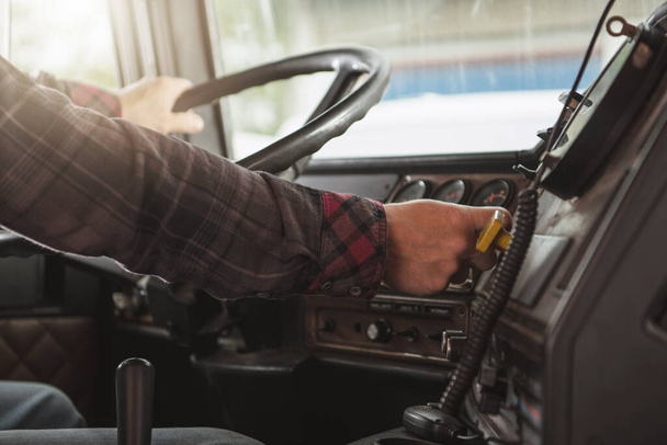 Semi Truck Male Driver Inside Of Vehicle Behind Steering Wheel. Transportation Industry Concept.  - Foto, immagini