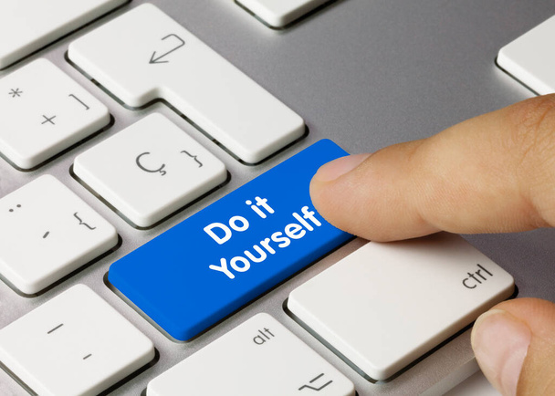 Do it Yourself Written on Blue Key of Metallic Keyboard. Finger pressing key - Photo, Image