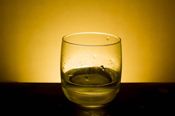 Elegant shot of a  glass of water on a dark background - Photo, image