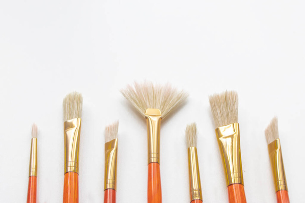 Different shape and size paint brushes on white isolated background. Set of brushes for painting. - Photo, Image