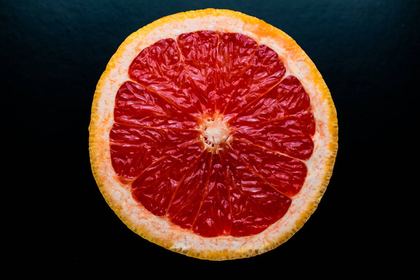 red grapefruit on black background - Foto, Imagen