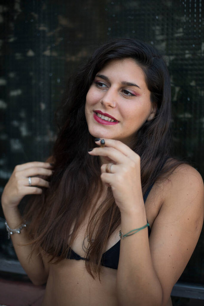 young girl smokes a cigar and laughs - Φωτογραφία, εικόνα