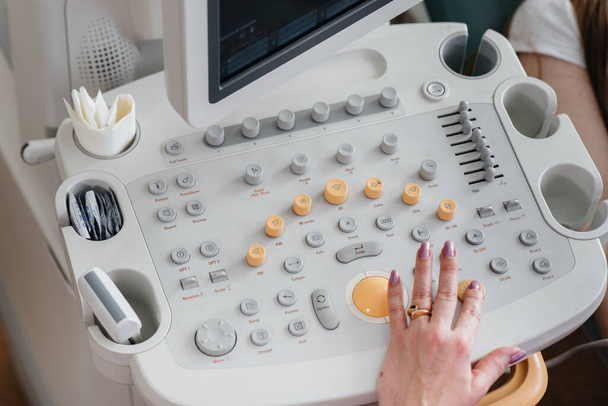 Close-up ultrasound device during a medical examination of a pregnant woman. Medical examination - Φωτογραφία, εικόνα