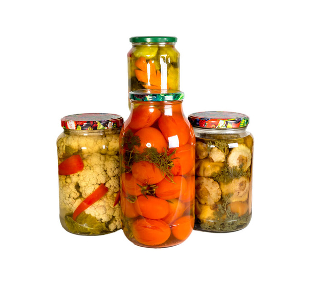 Several glass jars with canned vegetables. Isolated on white background. Homemade blanks. - Photo, Image