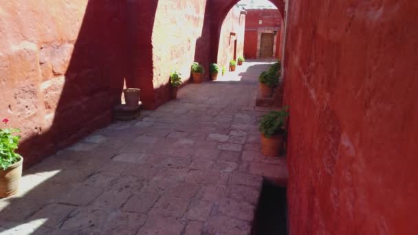 Red walls and arches in the courtyard of Saint Catherine Monastery. A monastery of nuns of the Dominican in Arequipa city, Peru. - Footage, Video