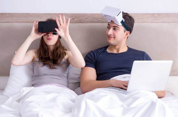Frau und Mann mit Virtual-Reality-Brille im Bett - Foto, Bild
