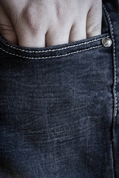 Vertical jeans close-up background with hand in pocket - Photo, Image