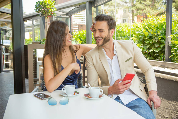 Attractive young couple smiling in cafe bar - Foto, Bild