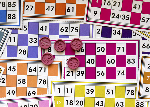 Barevné bingo herní karty a čísla na bílém pozadí, zblízka, izolované. - Fotografie, Obrázek