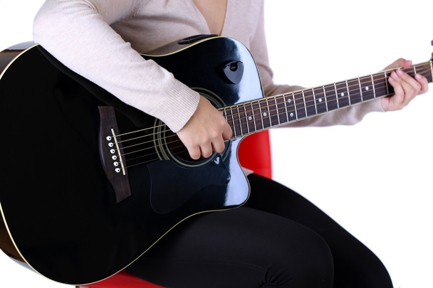 Acoustic guitar in female hands, isolated on white - Fotó, kép