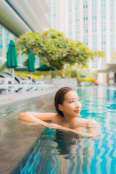 Portrait beautiful young asian woman relax happy smile leisure around outdoor swimming pool in resort - Photo, Image