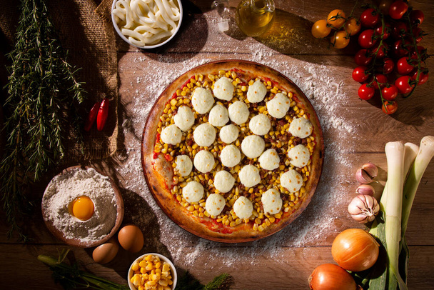 Pizza corn and cheese on wood background. Top view, close up. Traditional Brazilian Pizza - Fotó, kép
