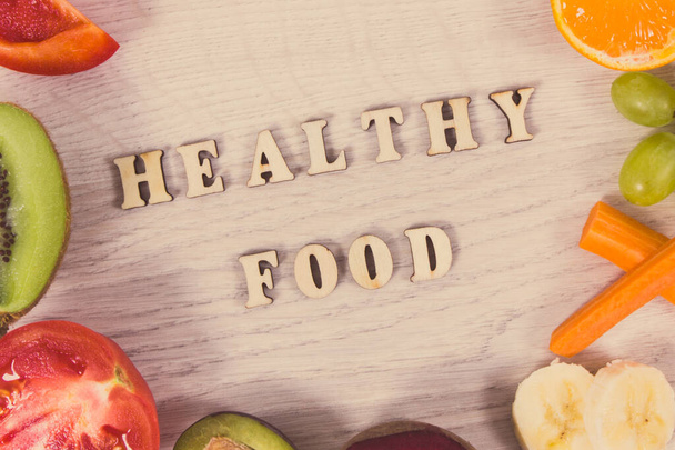 Надпись здоровое питание и свежие питательные фрукты и овощи в качестве источника витаминов, пищевых волокон и природных минералов
 - Фото, изображение